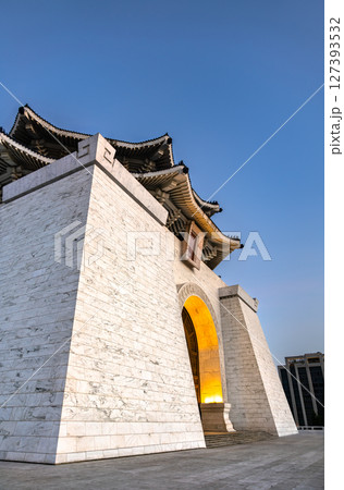 Low-angle perspective of Chiang Kai-Shek Memorial Hall's white-marble base and softly lit arched entrance, rising into a clear evening sky over downtown Taipei in Taiwan Low-angle perspective of Chiang Kai-Shek Memorial Hall's white-marble base and softly lit arched entrance, rising into a clear evening sky over downtown Taipei in Taiwan 127393532