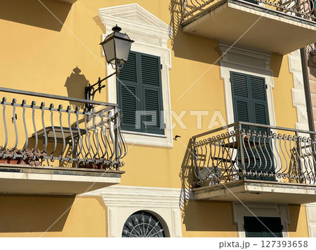 Old street in Italian countryside near sea. Traditional building. Sun day. Entrance, window to house. Old street in Italian countryside near sea. Traditional building. Sun day. Entrance, window to house. 127393658