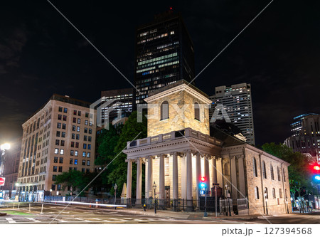 King's Chapel in Boston, Massachusetts, United States, stands brightly lit at a quiet downtown intersection, its stone portico and columns contrasting with modern high rises under a clear spring night King's Chapel in Boston, Massachusetts, United States, stands brightly lit at a quiet downtown intersection, its stone portico and columns contrasting with modern high rises under a clear spring night 127394568
