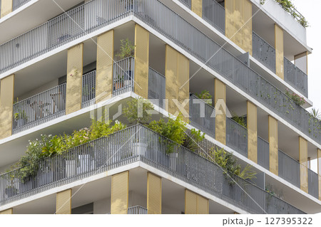 Modern building facade with balconies and plants growing in Montpellier, France Modern building facade with balconies and plants growing in Montpellier, France 127395322