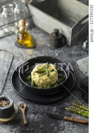 Creamy risotto with green asparagus seasoned with salt and pepper Creamy risotto with green asparagus seasoned with salt and pepper 127395332