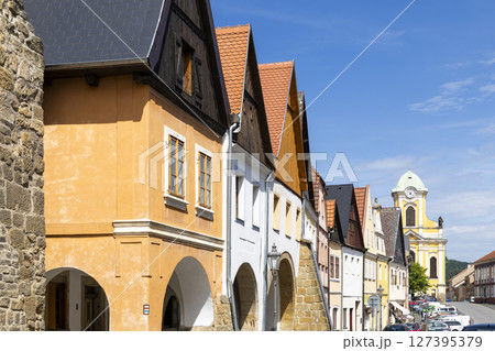 Colorful houses lining Mirove namesti square in Ustek, Czechia, with church tower in background Colorful houses lining Mirove namesti square in Ustek, Czechia, with church tower in background 127395379