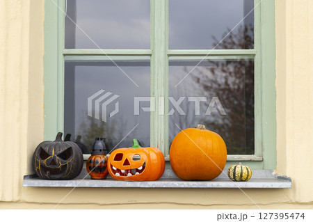 Halloween pumpkins and lanterns decorating a window sill in Banska Stiavnica, Slovakia 127395474