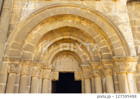 Romanesque archivolts decorating entrance of Santiago church in Aguero, Spain 127395498