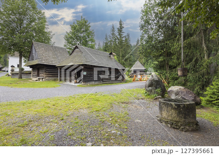Museum of the Orava Village in Zuberec showing traditional wooden houses and stone well in Slovakia 127395661