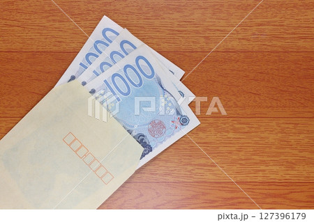 茶封筒に入れた千円札 127396179