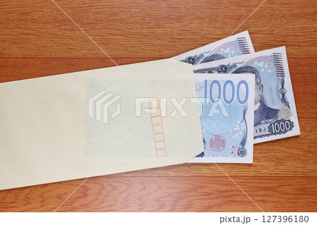 茶封筒に入れた千円札 127396180
