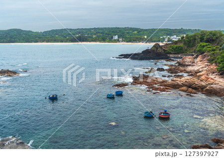 Landscape with Vietnamese basket boats in sea next to the rocks. Da Da reef or Ganh Da Dia in Vietnam. Aerial top view from drone 127397927
