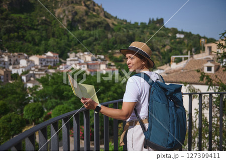 Woman Tourist Holding a Map Exploring a Beautiful Historic Village on a Sunny Day Woman Tourist Holding a Map Exploring a Beautiful Historic Village on a Sunny Day 127399411