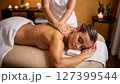 Woman having a back massage at a cosmetology and body care spa center. 127399544