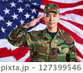 Asian american male soldier in uniform saluting on a background USA flag. 127399546