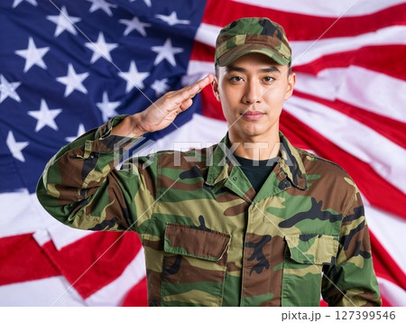 Asian american male soldier in uniform saluting on a background USA flag. Asian american male soldier in uniform saluting on a background USA flag. 127399546