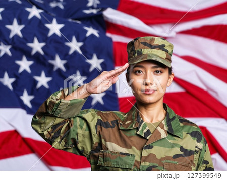 Asian american female soldier in uniform saluting on a background USA flag. 127399549