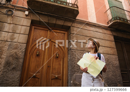 Female Tourist Exploring a Historical Street and Examining a City Map Female Tourist Exploring a Historical Street and Examining a City Map 127399666