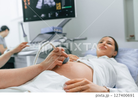 Close up view, scanning. Pregnant woman is lying down in the hospital, doctor does ultrasound Close up view, scanning. Pregnant woman is lying down in the hospital, doctor does ultrasound 127400691