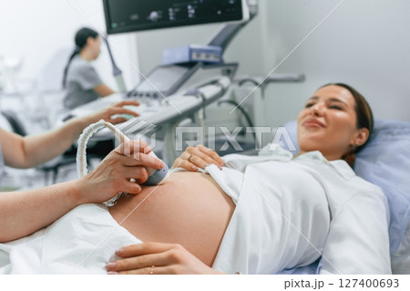 Close up view, scanning. Pregnant woman is lying down in the hospital, doctor does ultrasound Close up view, scanning. Pregnant woman is lying down in the hospital, doctor does ultrasound 127400693