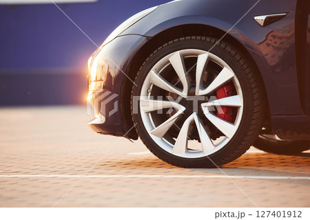 Close up view of tire of the modern automobile. Beautiful sunlight 127401912