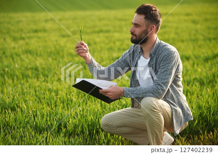Agricultural worker. Handsome young man is on the field 127402239