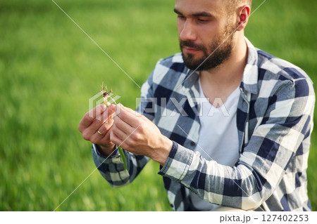 Agricultural worker. Handsome young man is on the field Agricultural worker. Handsome young man is on the field 127402253