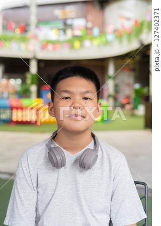 Portrait of Asian teenage boy with headphones 127402371