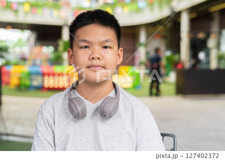 Portrait of Asian teenage boy with headphones 127402372