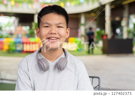 Portrait of Asian teenage boy with headphones 127402373