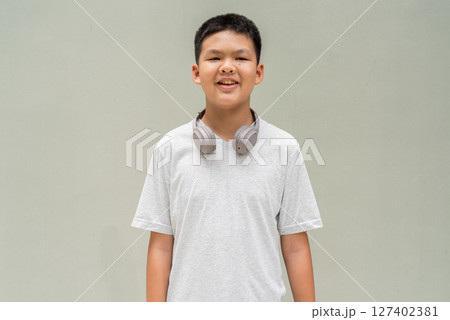 Thai Boy Portrait Against Plain Wall in Natural Light 127402381
