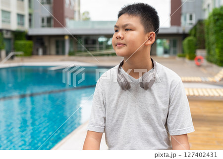 Teenage Boy at Poolside During Summer 127402431