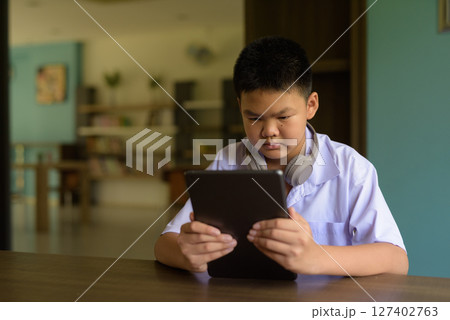 Thai Student in School Uniform Studying in Library 127402763
