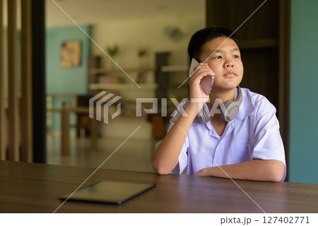 Thai Student in School Uniform Studying in Library 127402771