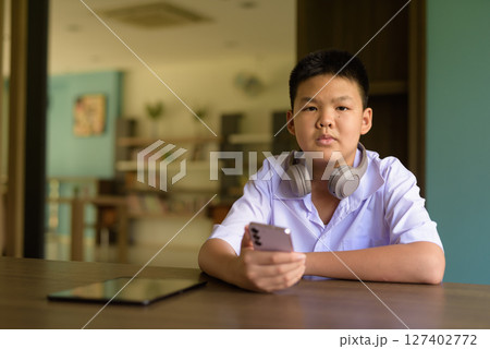Thai Student in School Uniform Studying in Library 127402772