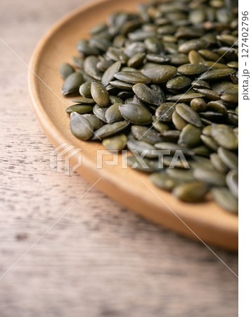 Peeled dry pepita pumpkin seeds background. Peeled dry pepita pumpkin seeds background. 127402796