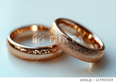 Pair of white gold wedding rings on a white background. Original style. 127403583