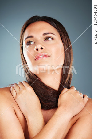 Hair, beauty and natural model with thinking face holding smooth, shiny and salon cosmetic texture. Health, skincare and hair care woman contemplating aesthetic in gray gradient studio. 127404098