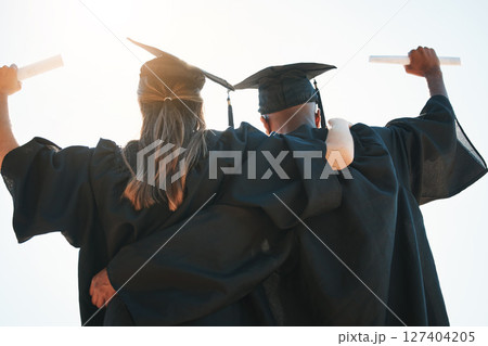 Graduation, education and goal with a man and woman university or college graduate in celebration together. Celebration, back and certificate with a male and female pupil cheering their achievement 127404205