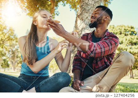 Pizza, food and picnic with a diversity couple in a park during summer for a romantic date together. Fast food, eating and love with a man and woman dating or bonding in a garden for romance and fun Pizza, food and picnic with a diversity couple in a park during summer for a romantic date together. Fast food, eating and love with a man and woman dating or bonding in a garden for romance and fun 127404256