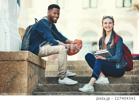Education, campus friends and diversity students relax before college lecture class, learning or study course. University, knowledge and school portrait of woman and black man on football scholarship 127404341
