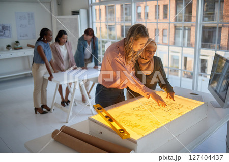 Architect, business women and diversity of engineering building team planning a project. Light on industrial illustration with engineer group working on a teamwork collaboration and design strategy 127404437