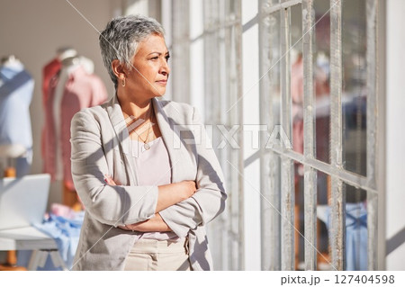 Woman, thinking and arms crossed at office window for vision, planning work or fashion startup idea motivation. Clothes design manager, creative leader and stratergy dream or workplace inspiration 127404598