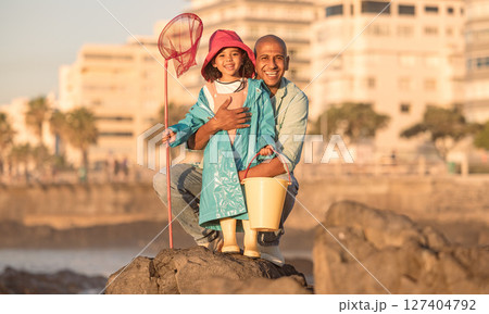 Father, daughter and fishing portrait with a man and child on a ocean holiday for bonding with love. Fish, net and bucket with a dad and girl kid relaxing together to catch fish on a seaside vacation 127404792