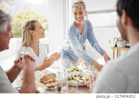 Thanksgiving, dinner and woman serving food to family for festive celebration meal, lunch and feast. Love, happiness and big family enjoying holiday, vacation and festival tradition in family home 127404852