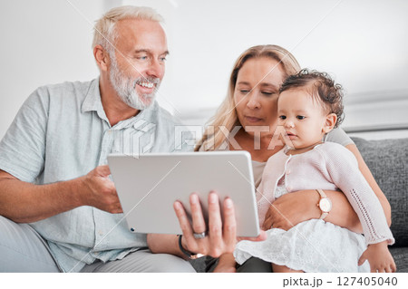 Family, tablet and baby with grandparents on sofa in home on social media, streaming movie or educational app. Relax, love and grandpa, grandma and infant or child with touchscreen tech for cartoons. Family, tablet and baby with grandparents on sofa in home on social media, streaming movie or educational app. Relax, love and grandpa, grandma and infant or child with touchscreen tech for cartoons. 127405040