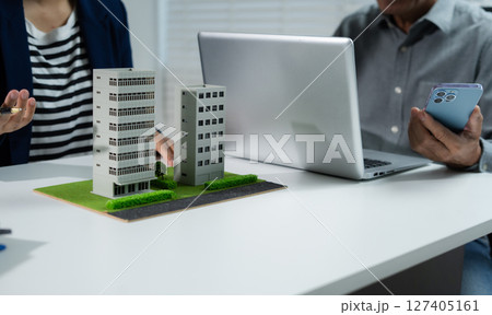 House model with agent asking costumer for contract to buy, get insurance or loan real estate or property. House model with agent asking costumer for contract to buy, get insurance or loan real estate or property. 127405161