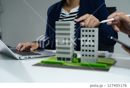 House model with agent asking costumer for contract to buy, get insurance or loan real estate or property. House model with agent asking costumer for contract to buy, get insurance or loan real estate or property. 127405176