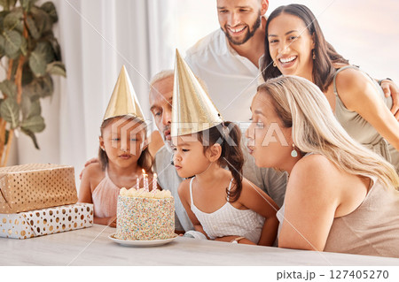 Family, kids and birthday cake with a child and her big family celebrating with a party for fun event. Generations, mother and father with grandparents and grandkids celebrate with dessert or candles 127405270
