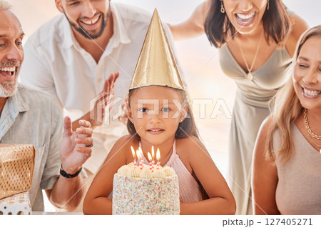 Birthday, candles on birthday cake and child with big family celebrate party event, sing together and show girl love in apartment home. Happy mother, father and child bonding with grandparents smile 127405271
