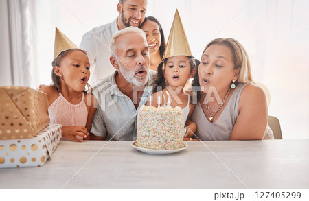 Big family celebration party, birthday cake and children blow candle fire to celebrate annual event with present and gift box. Love bond, youth growth congratulations and childhood memory of sisters 127405299