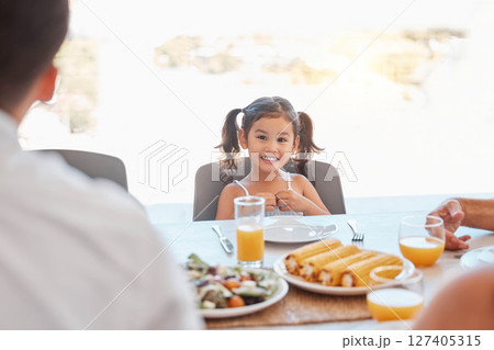 Child, girl or family lunch meal at dining table for holiday celebration, reunion or social gathering. Portrait, smile or happy kid with healthy food in house, home or restaurant and bonding at party 127405315
