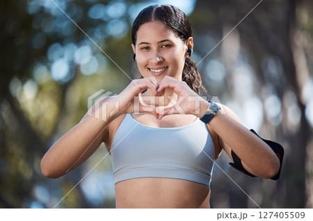 Fitness portrait, heart hands and woman in nature with sign for affection or love emoji outdoors. Health, wellness and female athlete in park with hand symbol for support while preparing for training Fitness portrait, heart hands and woman in nature with sign for affection or love emoji outdoors. Health, wellness and female athlete in park with hand symbol for support while preparing for training 127405509