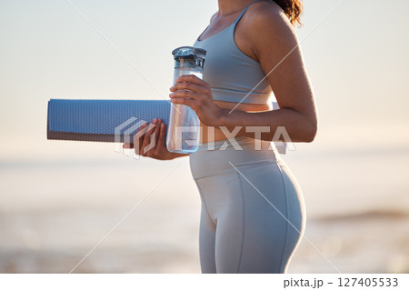Beach, water bottle of body of woman with yoga mat for pilates workout freedom, fitness or exercise in nature peace. Self care, healthy mindset and sports girl ready for morning wellness training 127405533